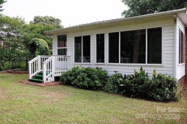 view of side of home featuring a yard