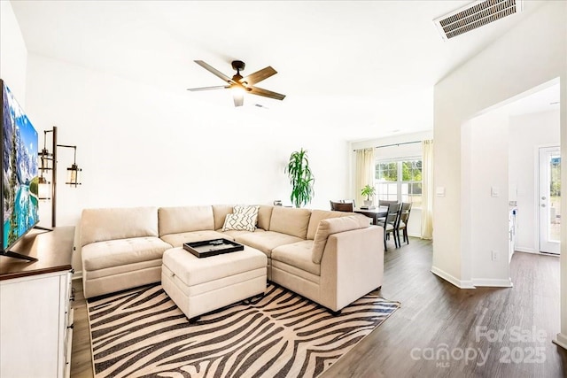 living area with ceiling fan, wood finished floors, and baseboards