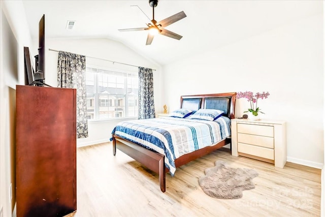 bedroom with wood finished floors, baseboards, lofted ceiling, and a ceiling fan