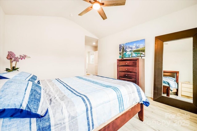 bedroom with wood finished floors, lofted ceiling, and a ceiling fan