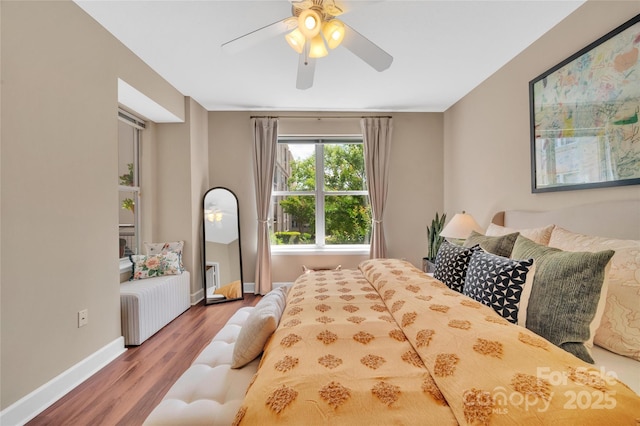bedroom with wood finished floors, baseboards, and a ceiling fan