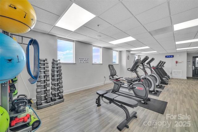 workout area with wood finished floors and baseboards