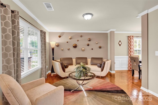 12217 Dearview Ln, Charlotte, NC 28269 - living area featuring light wood-style flooring, crown molding, and wainscoting