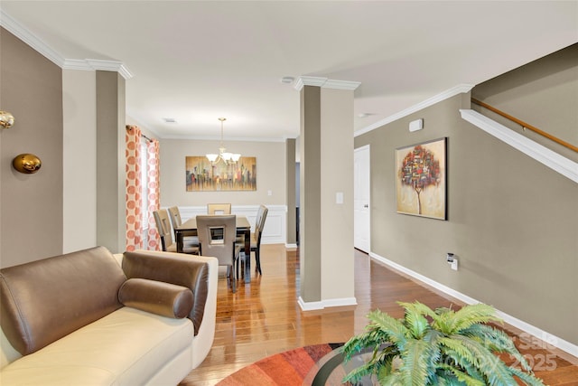 12217 Dearview Ln, Charlotte, NC 28269 - living area with a chandelier, ornate columns, wood finished floors, ornamental molding, and baseboards