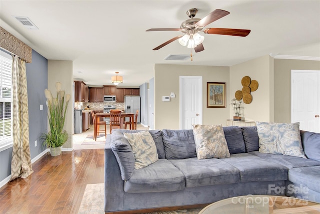 12217 Dearview Ln, Charlotte, NC 28269 - living room with ceiling fan, light wood-style flooring, and baseboards