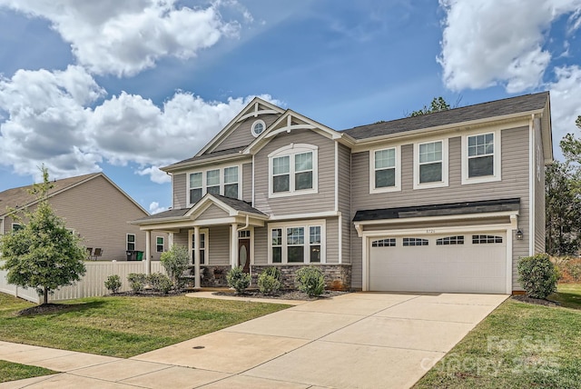 craftsman inspired home featuring a porch, concrete driveway, a garage, and stone siding