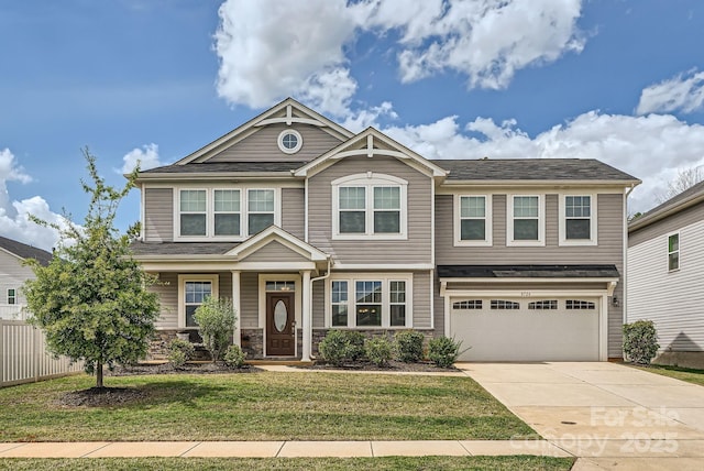 craftsman-style home with an attached garage, driveway, and stone siding