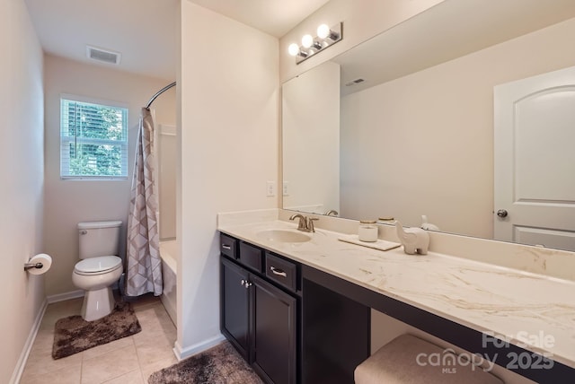 bathroom featuring toilet, tile patterned flooring, baseboards, vanity, and shower / bath combo with shower curtain