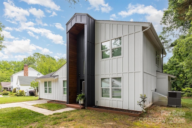 6824 Cortez Trl, Charlotte, NC 28227 - view of side of property featuring board and batten siding, a yard, and cooling unit