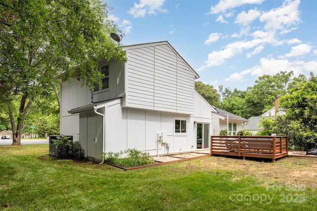6824 Cortez Trl, Charlotte, NC 28227 - back of property featuring a lawn, a wooden deck, and board and batten siding