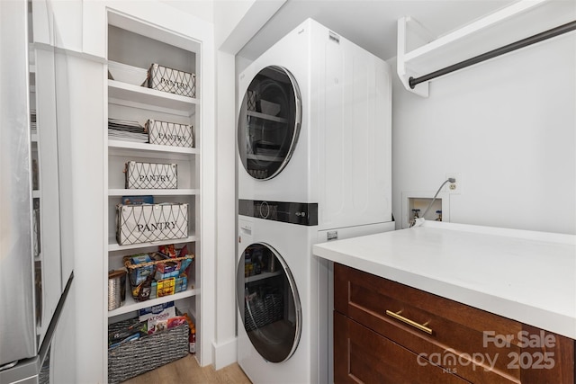 6824 Cortez Trl, Charlotte, NC 28227 - laundry area with stacked washing machine and dryer and light wood-type flooring