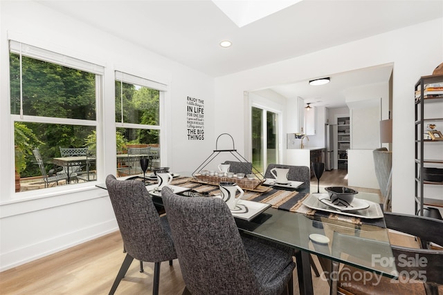 6824 Cortez Trl, Charlotte, NC 28227 - dining area with light wood-style flooring, a skylight, recessed lighting, and baseboards