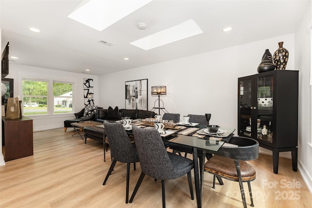 6824 Cortez Trl, Charlotte, NC 28227 - dining room with a skylight, light wood-style flooring, recessed lighting, and baseboards