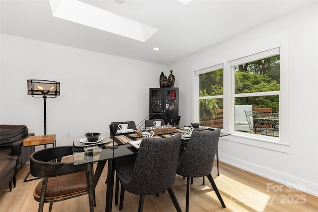 6824 Cortez Trl, Charlotte, NC 28227 - dining area featuring a skylight, light wood-type flooring, baseboards, and recessed lighting