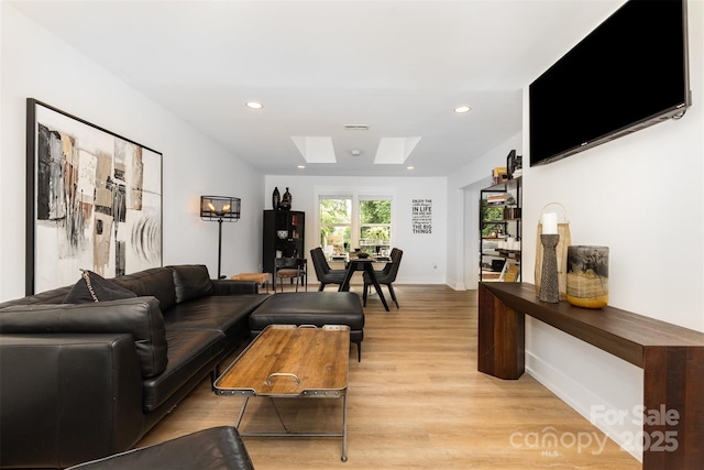 6824 Cortez Trl, Charlotte, NC 28227 - living room with a skylight, light wood-style flooring, recessed lighting, and baseboards