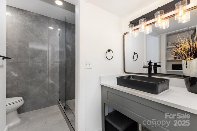 6824 Cortez Trl, Charlotte, NC 28227 - bathroom with a tile shower, vanity, toilet, and tile patterned flooring