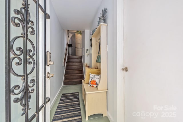 staircase featuring baseboards and tile patterned flooring