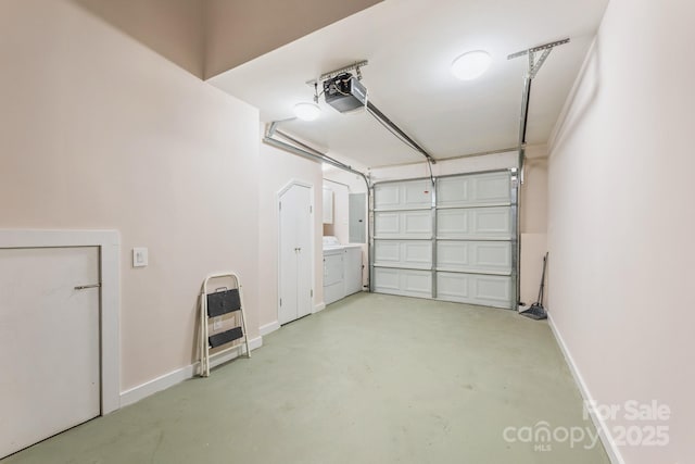 garage with a garage door opener, independent washer and dryer, electric panel, and baseboards