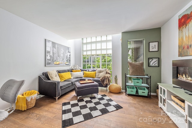 415 W 7th St Unit F, Charlotte, NC 28202 - living area featuring hardwood / wood-style floors and a lit fireplace