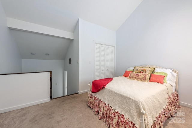 415 W 7th St Unit F, Charlotte, NC 28202 - bedroom featuring vaulted ceiling, carpet, a closet, and baseboards