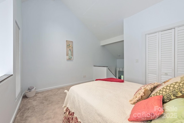 415 W 7th St Unit F, Charlotte, NC 28202 - carpeted bedroom with vaulted ceiling, a closet, and baseboards