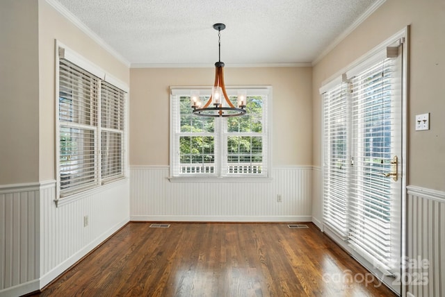 1295 Patterson St, China Grove, NC 28023 - unfurnished dining area featuring a wainscoted wall, wood finished floors, a chandelier, a textured ceiling, and ornamental molding