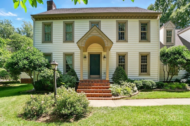 1295 Patterson St, China Grove, NC 28023 - colonial-style house featuring a front yard and a chimney