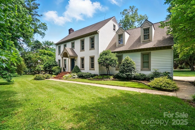 1295 Patterson St, China Grove, NC 28023 - colonial-style house with a chimney, a front yard, and a shingled roof