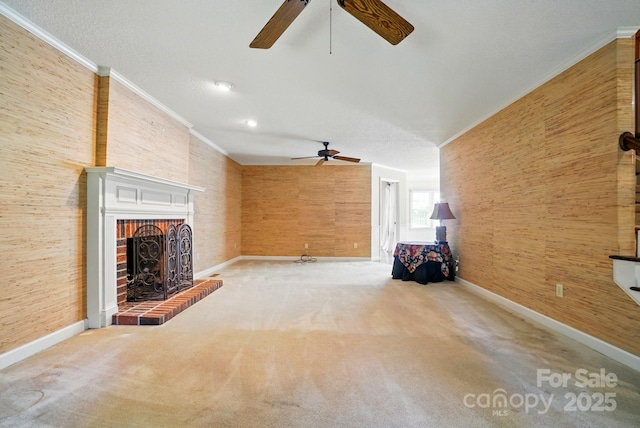1295 Patterson St, China Grove, NC 28023 - unfurnished living room featuring a ceiling fan, ornamental molding, baseboards, a brick fireplace, and carpet floors