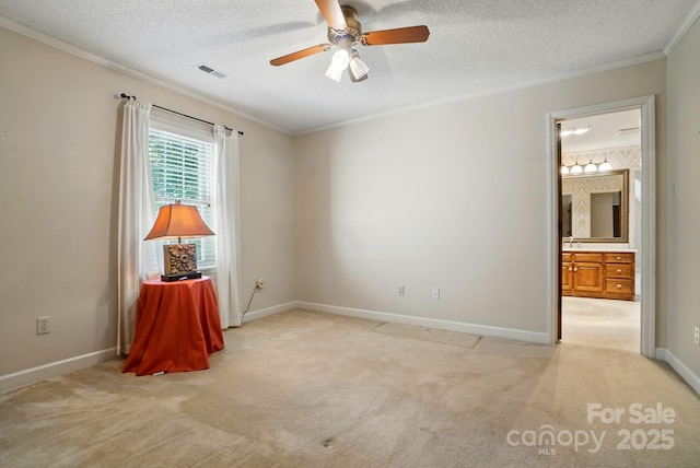 1295 Patterson St, China Grove, NC 28023 - spare room featuring crown molding, light carpet, ceiling fan, baseboards, and a textured ceiling