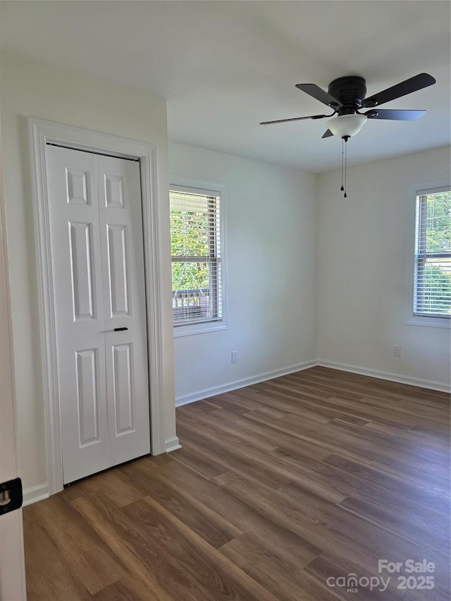1111 Unionville Church Rd, Monroe, NC 28110 - unfurnished bedroom with dark wood-type flooring, baseboards, a closet, and a ceiling fan