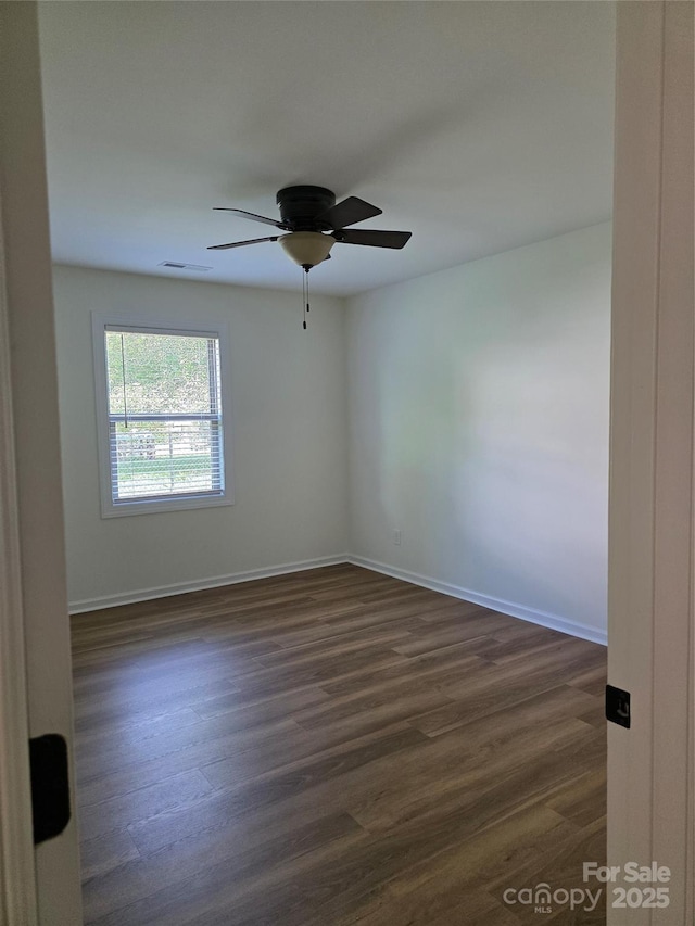1111 Unionville Church Rd, Monroe, NC 28110 - spare room featuring dark wood-style floors, a ceiling fan, and baseboards