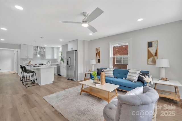 1829 Jennings St, Charlotte, NC 28216 - living room featuring a ceiling fan, light wood-style flooring, healthy amount of natural light, recessed lighting, and baseboards