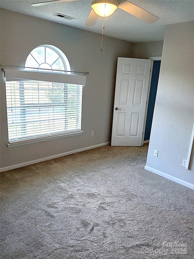 12304 Sandringham Pl, Charlotte, NC 28262 - carpeted empty room with baseboards, ceiling fan, and a textured ceiling