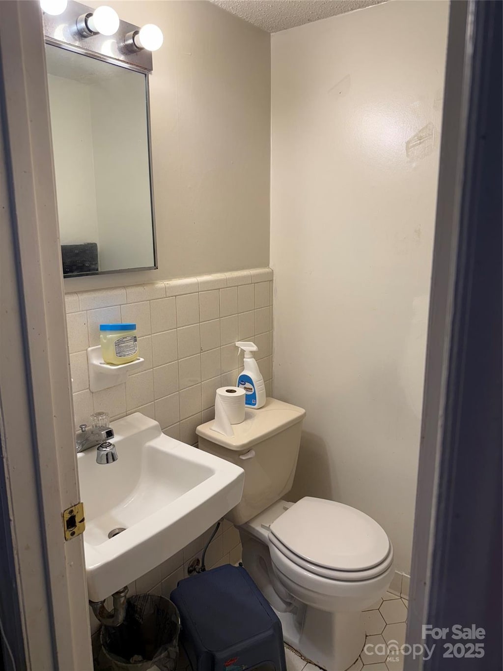 2224 Yorkhills Dr Unit 7, Charlotte, NC 28217 - half bathroom featuring toilet, tile walls, and a sink