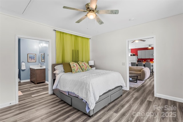35 Telephone Exchange Rd, Hickory, NC 28601 - bedroom featuring fridge, wood finished floors, baseboards, and connected bathroom