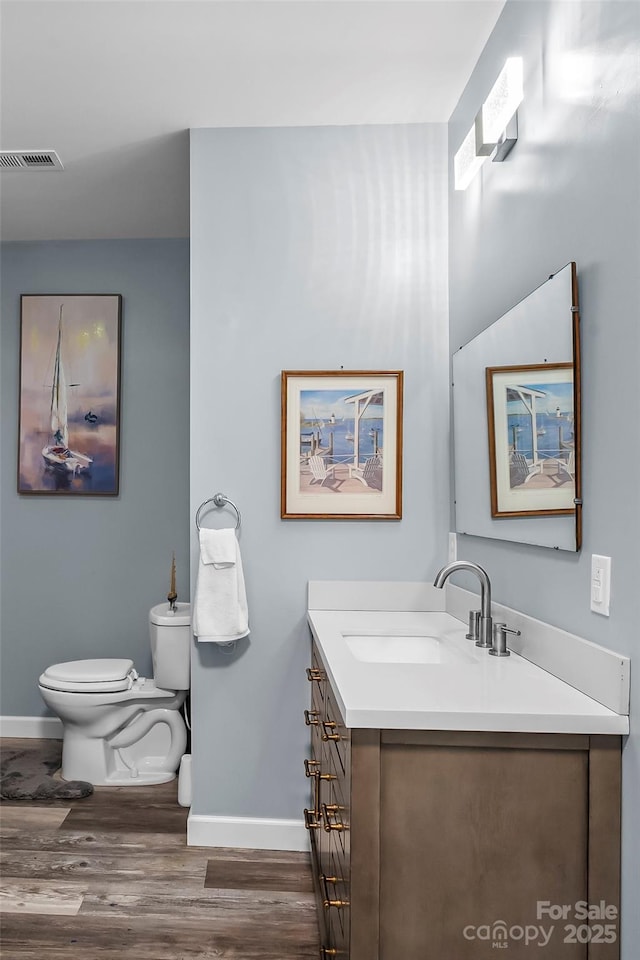 35 Telephone Exchange Rd, Hickory, NC 28601 - bathroom featuring baseboards, vanity, wood finished floors, and toilet