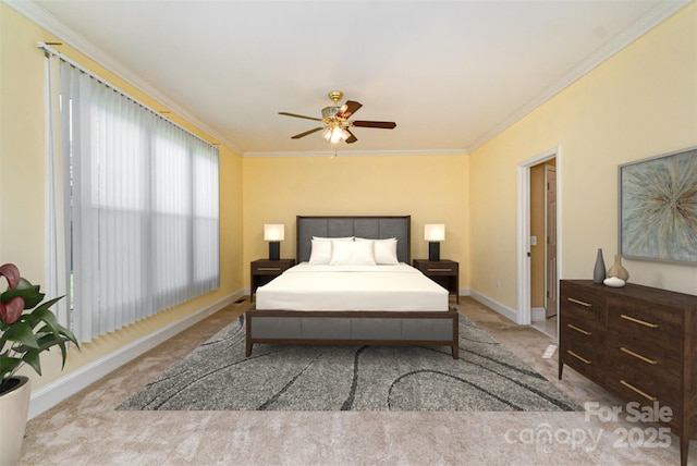 carpeted bedroom featuring ornamental molding, baseboards, and ceiling fan