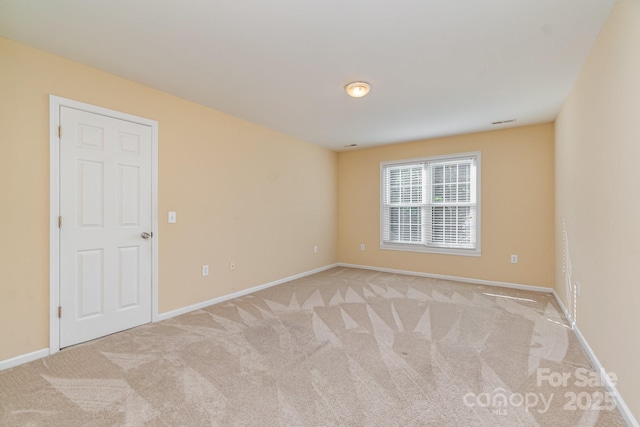 carpeted empty room with baseboards