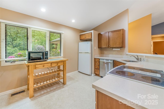 30 Robin Ln, Asheville, NC 28806 - kitchen with freestanding refrigerator, stainless steel dishwasher, a sink, brown cabinetry, and light countertops