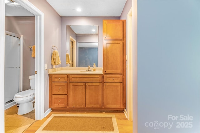 30 Robin Ln, Asheville, NC 28806 - full bathroom with a stall shower, toilet, wood finished floors, vanity, and recessed lighting