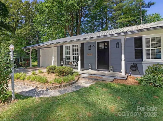 150 Deerwoode Ln, Brevard, NC 28712 - view of front of home with an attached garage, metal roof, a standing seam roof, and a porch