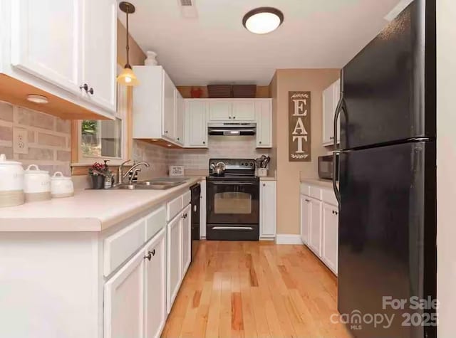150 Deerwoode Ln, Brevard, NC 28712 - kitchen featuring black appliances, ventilation hood, a sink, white cabinetry, and decorative backsplash