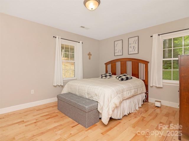 150 Deerwoode Ln, Brevard, NC 28712 - bedroom featuring light wood-style floors, multiple windows, and baseboards