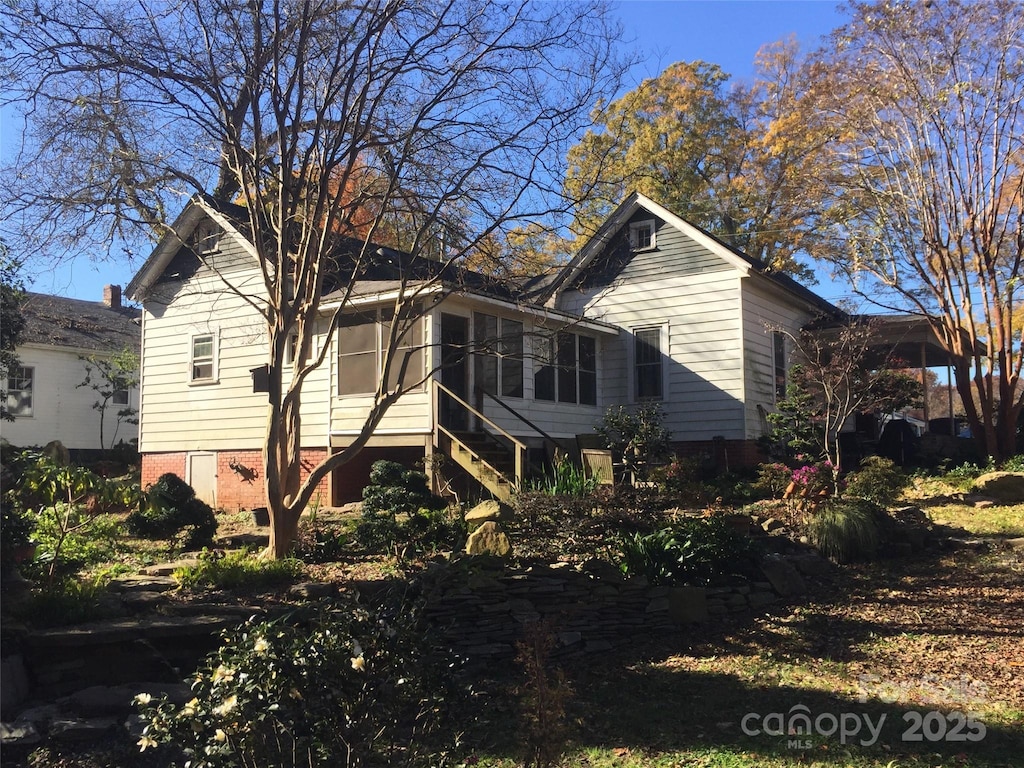 view of side of property with stairs