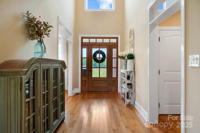 3707 Seagrave Farm Rd, Concord, NC 28025 - entryway with a towering ceiling, light wood-style floors, and baseboards