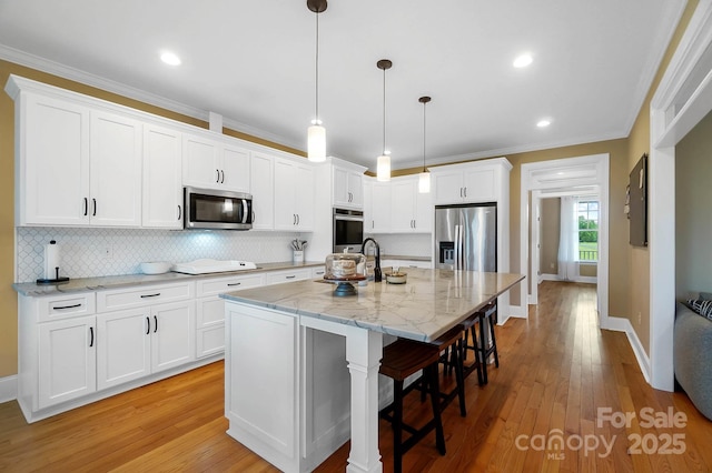 3707 Seagrave Farm Rd, Concord, NC 28025 - kitchen with appliances with stainless steel finishes, a sink, white cabinets, baseboards, and crown molding