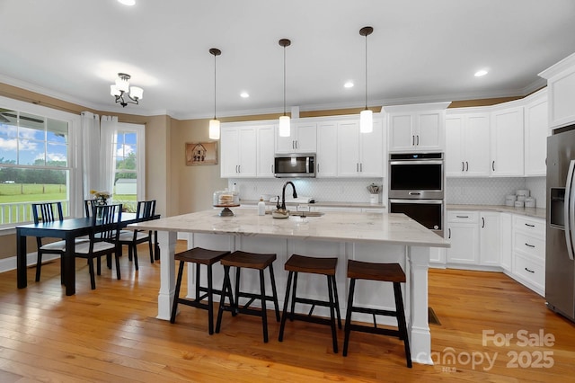 3707 Seagrave Farm Rd, Concord, NC 28025 - kitchen with appliances with stainless steel finishes, decorative backsplash, a sink, white cabinets, and crown molding