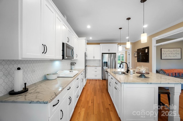 3707 Seagrave Farm Rd, Concord, NC 28025 - kitchen with a sink, appliances with stainless steel finishes, a breakfast bar area, white cabinets, and light stone counters