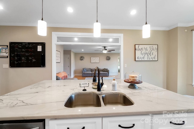 3707 Seagrave Farm Rd, Concord, NC 28025 - kitchen featuring a sink, open floor plan, a ceiling fan, light stone countertops, and crown molding